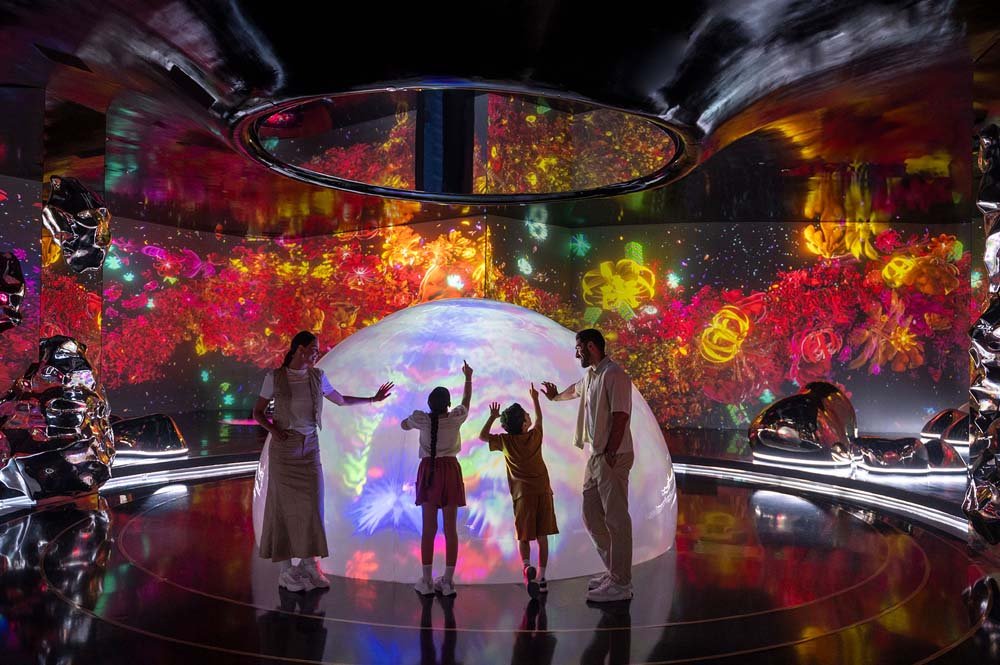 Families exploring technologically enhanced art at AYA Universe