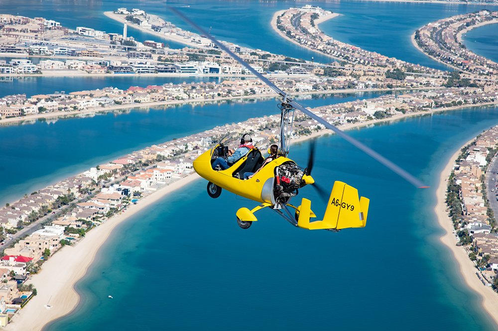 Gyrocopter flying over Dubai Palm Jumeirah Island